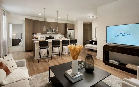 A modern living room with a black coffee table and a flat screen TV.