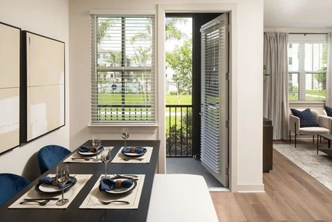 A dining room with a table set for four.