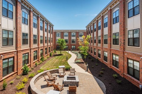 A courtyard surrounded by red brick buildings.