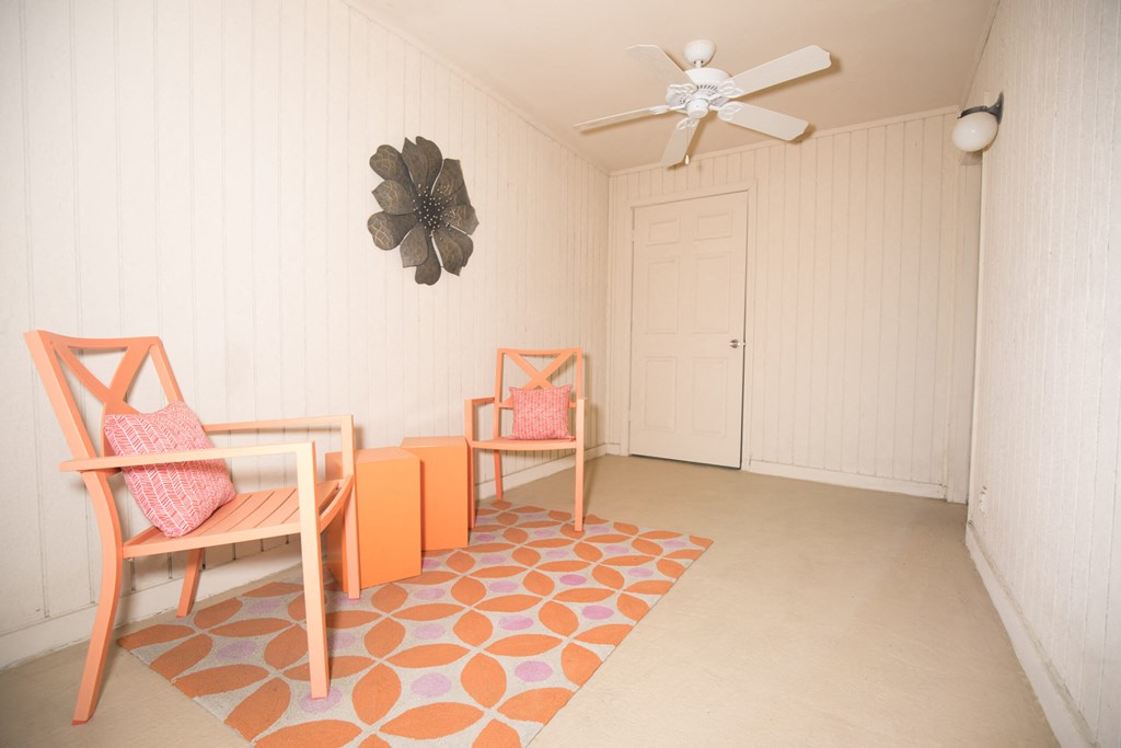 a dining room with chairs and a table and a ceiling fan