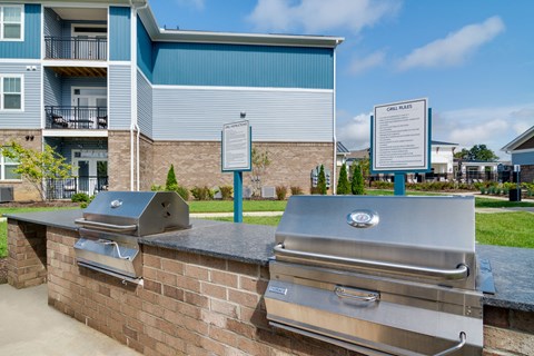 A wall of grills is in front of a building.