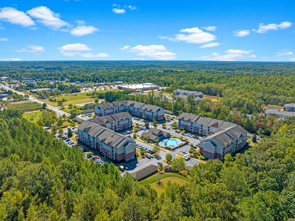 a aerial view of a building complex surrounded by trees