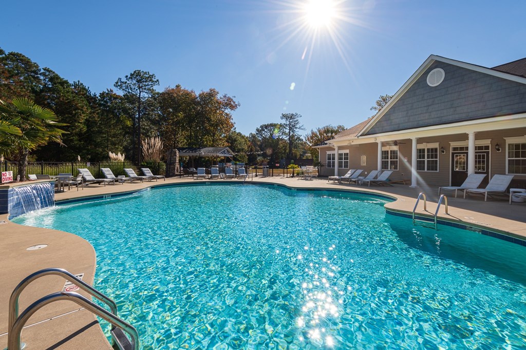 A large swimming pool with a sunny sky above.