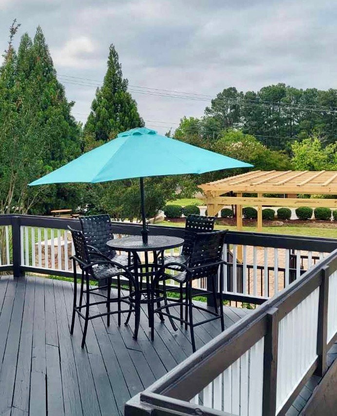 a table and chairs with an umbrella on a deck