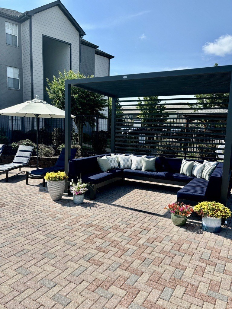 a patio with couches and a canopy