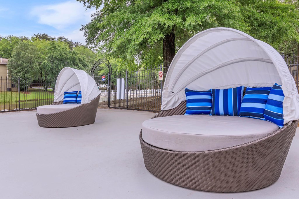 Lounge chair by swimming pool at Enclave at 38 Twenty Two Apartments in Greensboro, NC