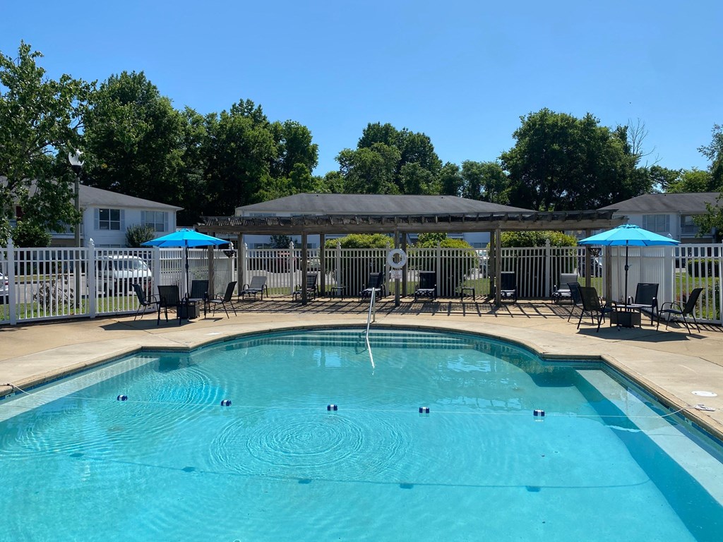 a swimming pool with umbrellas and chairs around it