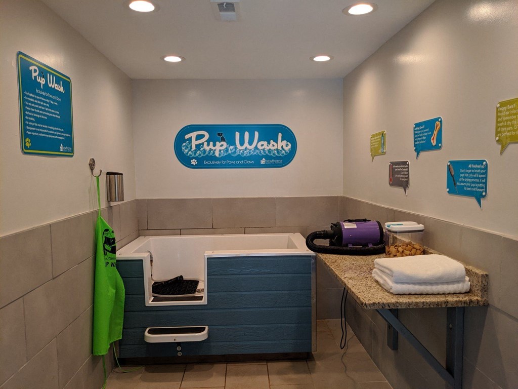 a bathroom with a bath tub and a counter with a bundle of towels