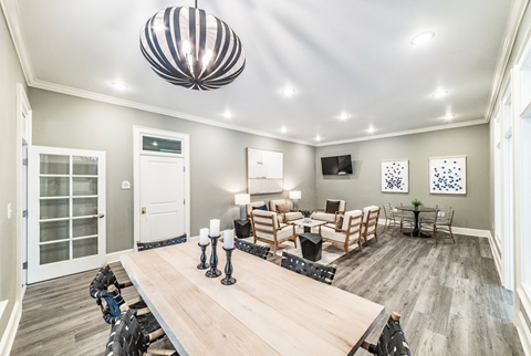 A dining room with a wooden table and chairs.