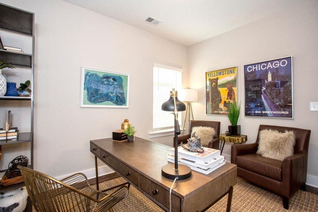 a living room with a desk and a couch