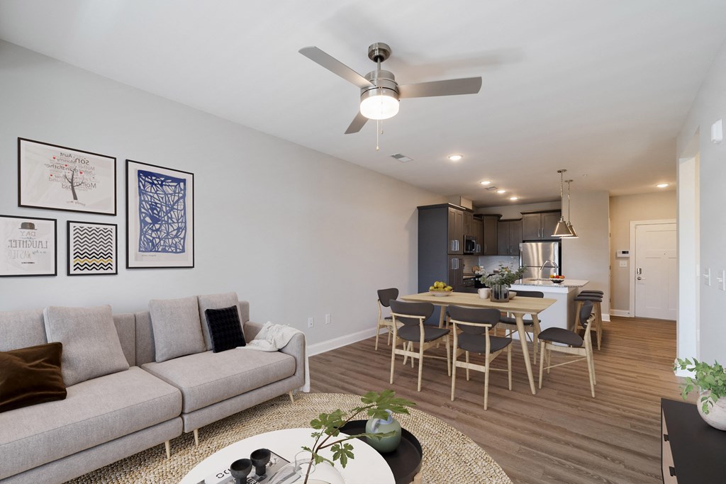 a living room with a couch and a table with chairs