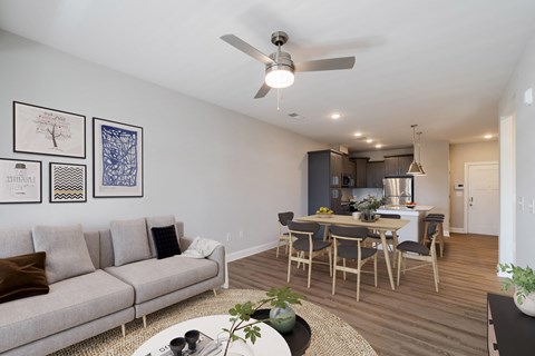 a living room with a couch and a table with chairs