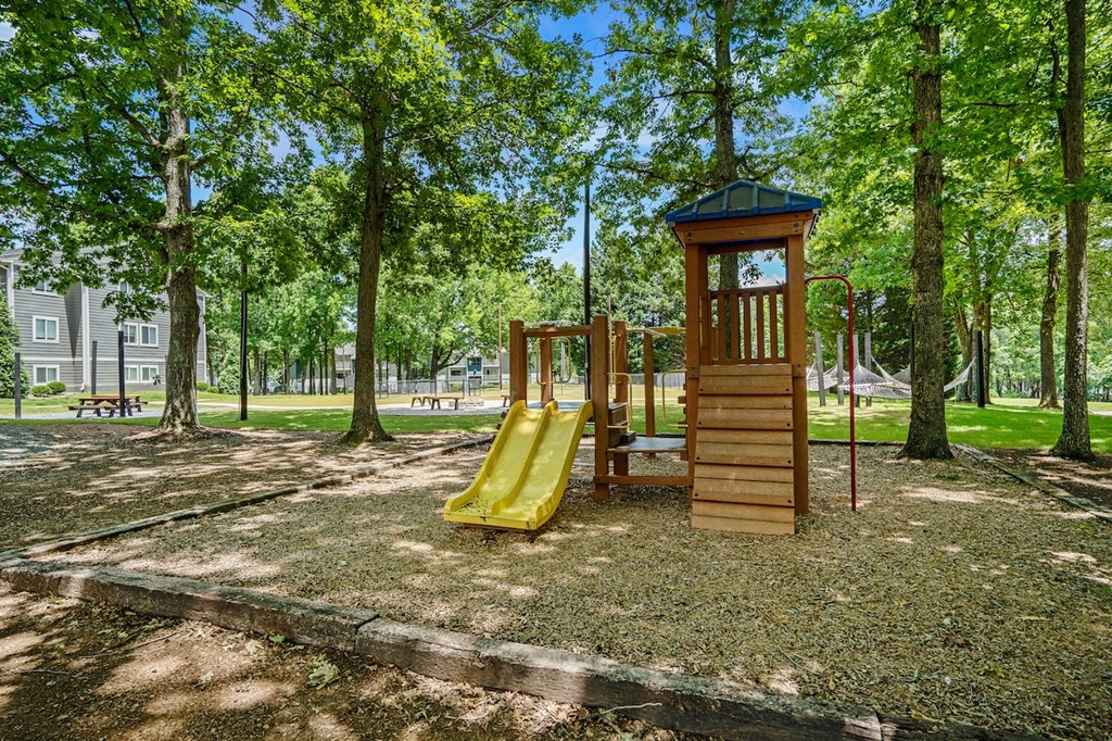 a playground with a wooden tower with a clock on it