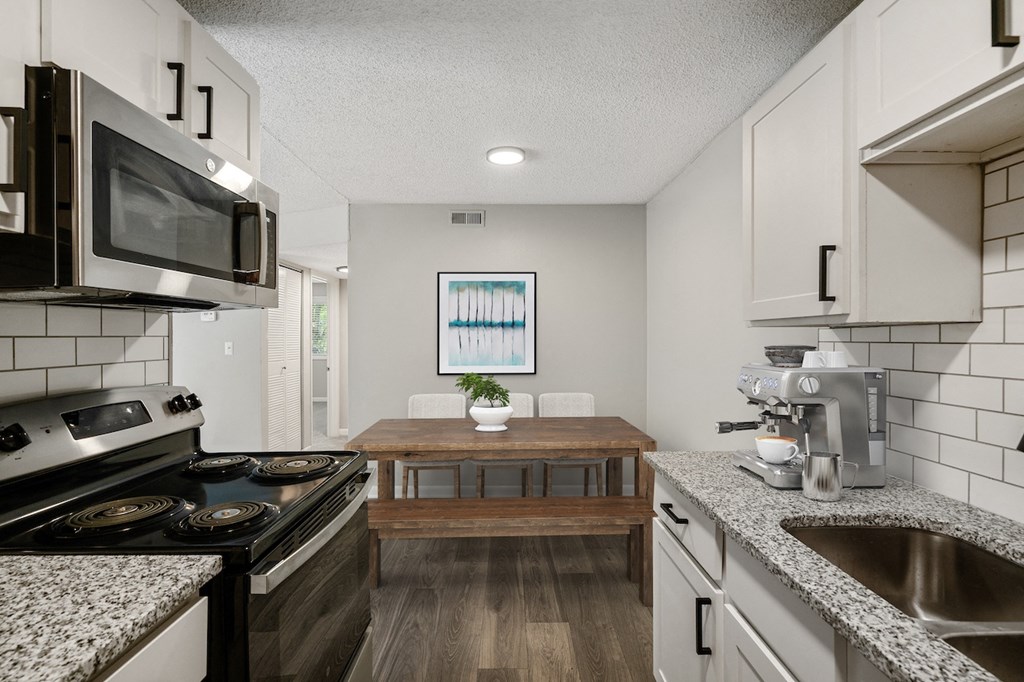 a kitchen and dining area in a 555 waverly unit