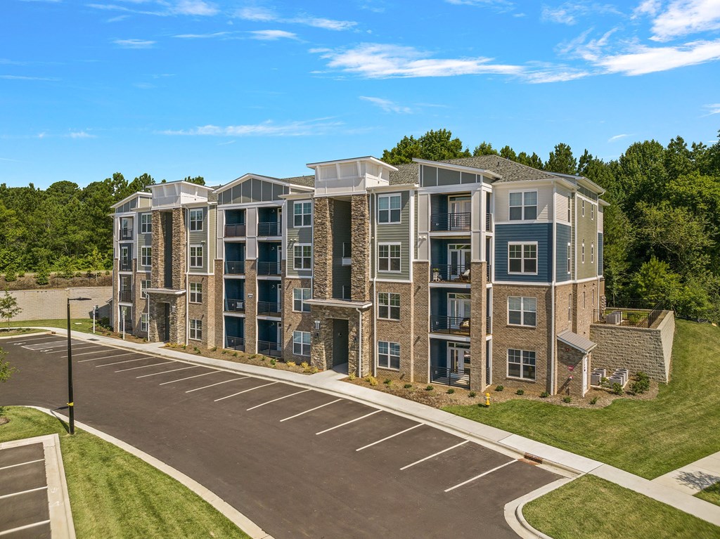 a large apartment complex with a road in front of it