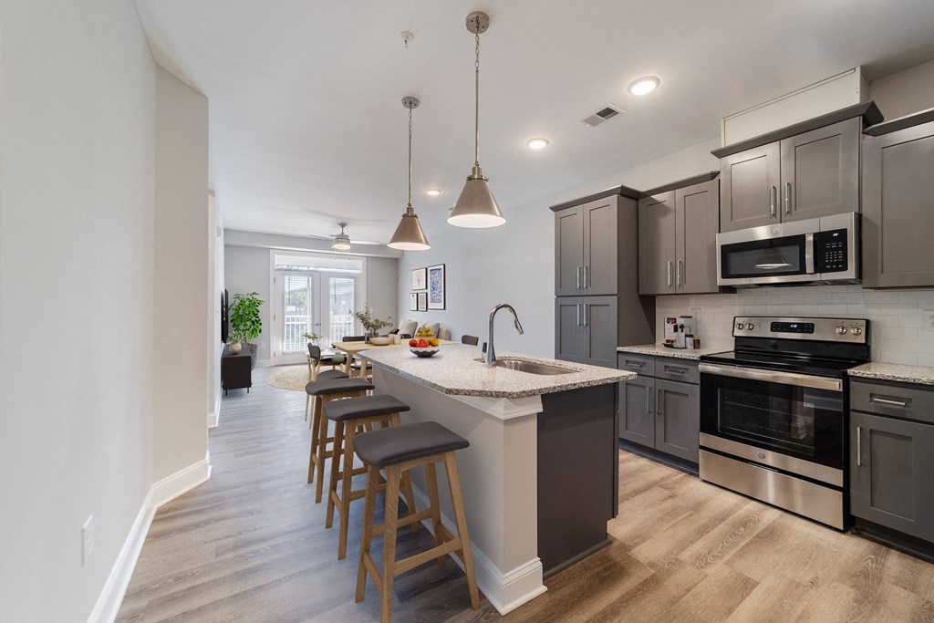 an open kitchen with a large island with stools