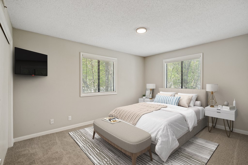 a bedroom with a bed and two windows