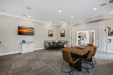 a dining room with a table and chairs and a kitchen