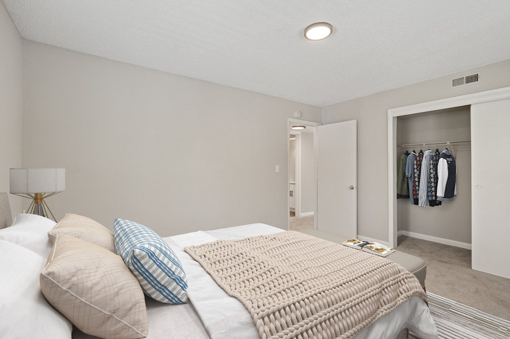 a bedroom with a large bed and a closet