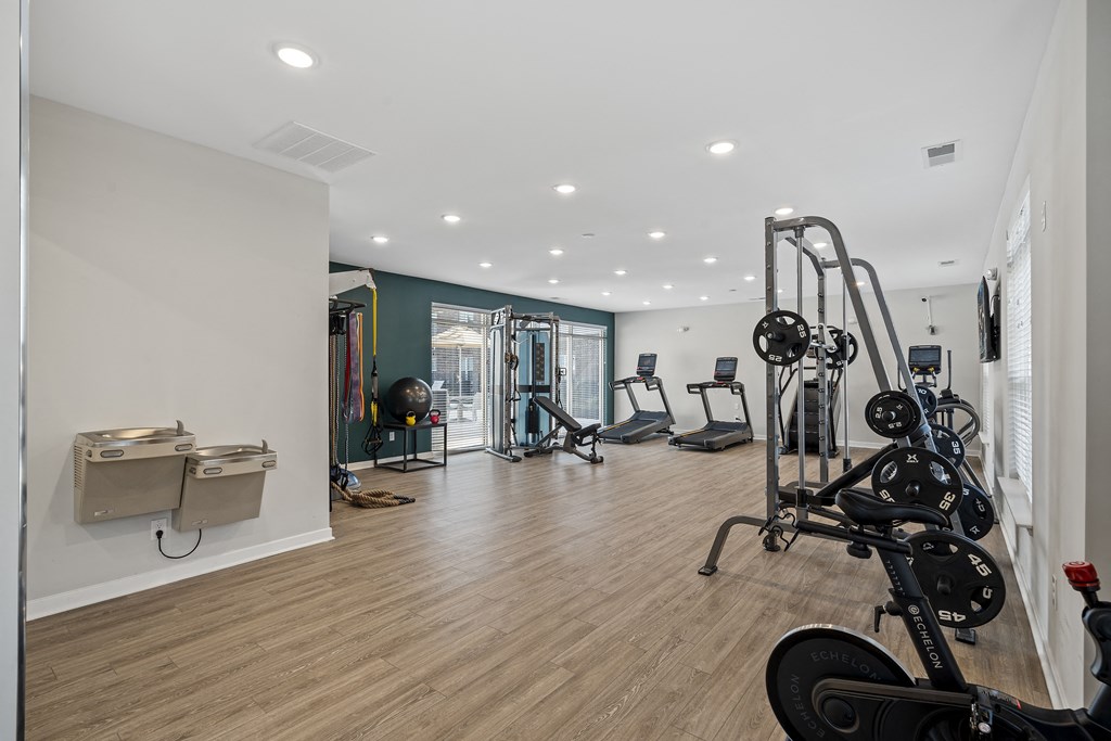 a workout room with weights and other exercise equipment