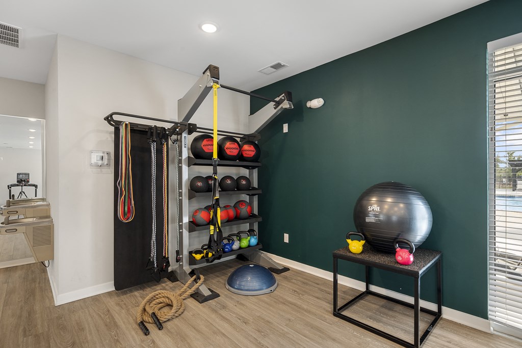 a home gym with a green accent wall