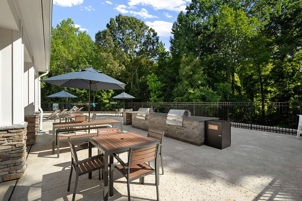 an outdoor patio with tables and umbrellas