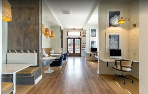 a reception area with desks and chairs and a fireplace