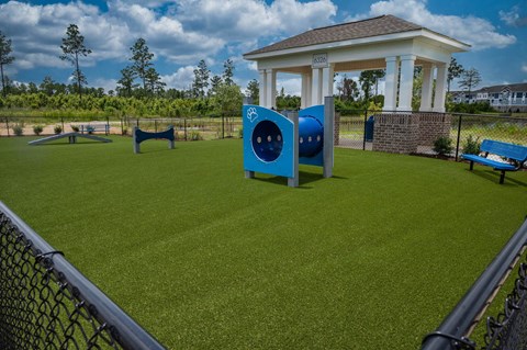 A park with a gazebo and a blue sculpture.