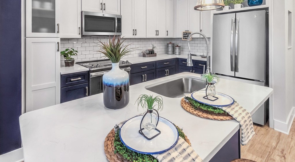 a white kitchen with a sink and a counter top