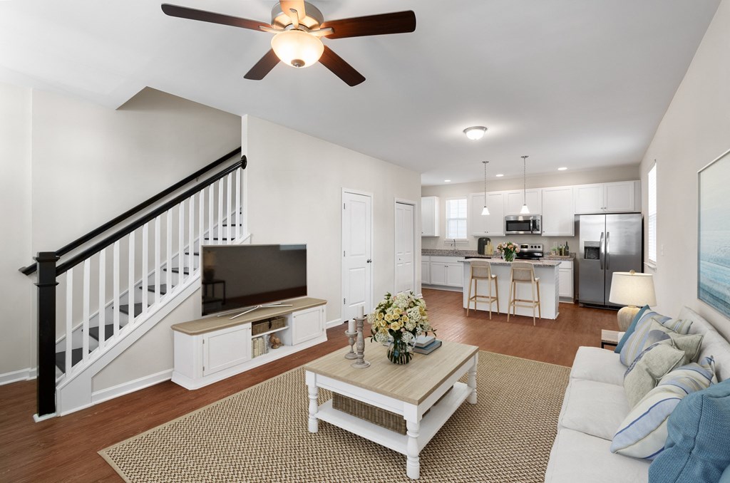 A living room with a white couch and a coffee table.