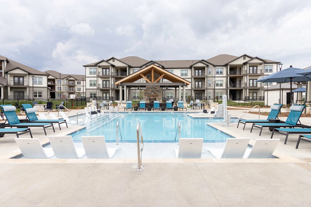 A large swimming pool in front of apartment buildings at the Wilmont at Hendersonville Apartments in Hendersonville,NC