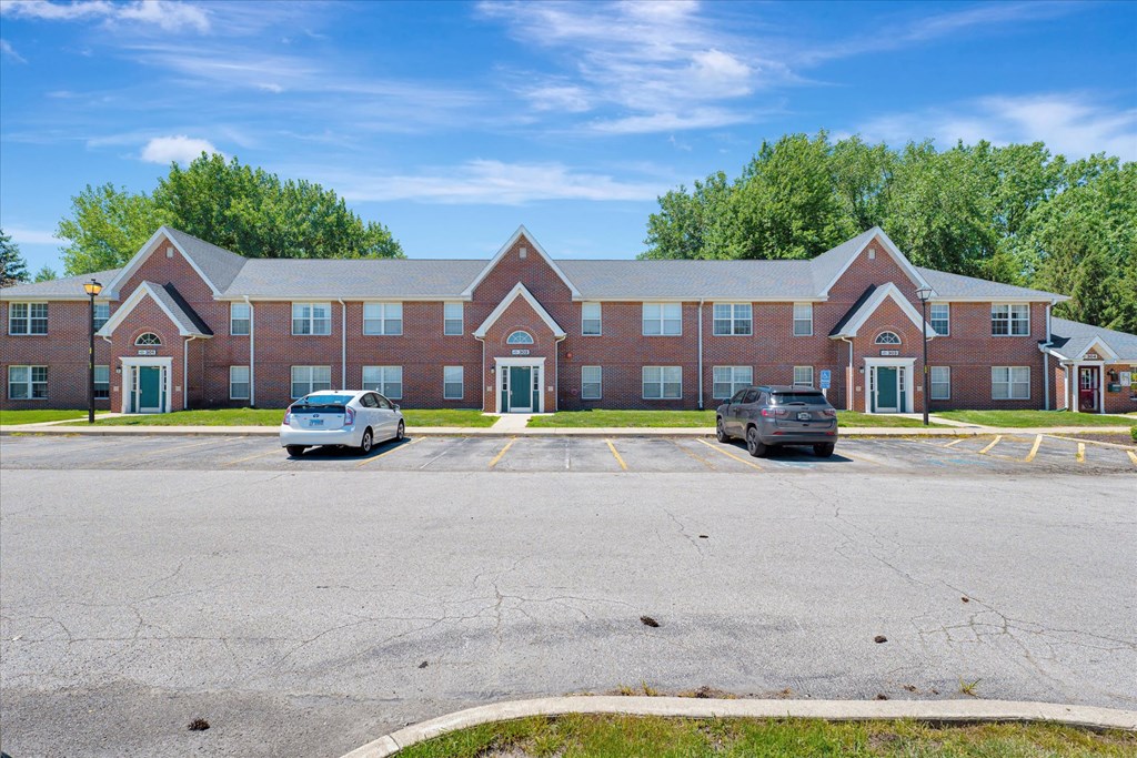 a large brick building with cars parked in front of it