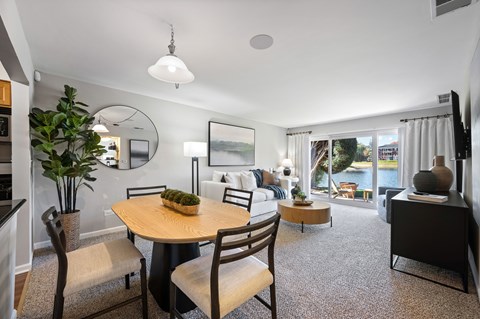 Open concept living and dining area with lake view at Versailles on the Lakes Schaumburg Apartments, Schaumburg