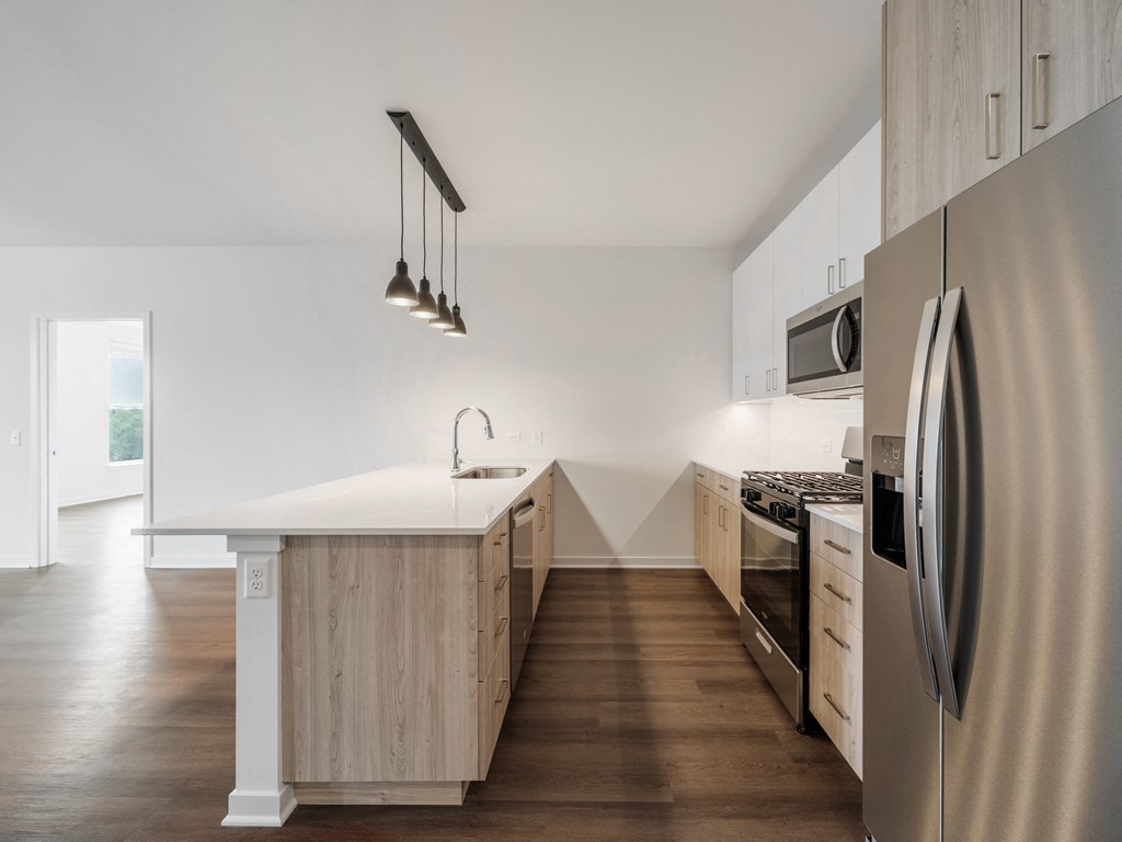 a kitchen with a large island and stainless steel appliances