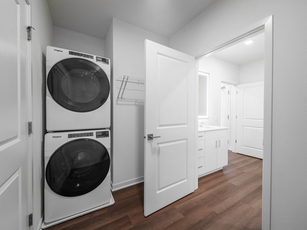 white laundry room with washer and dryer in a small apartment