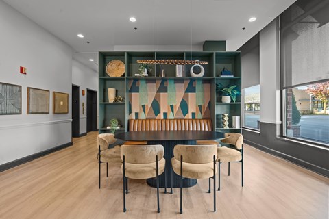 A modern dining room with a long table and chairs.