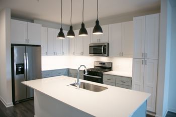 a kitchen with white counter tops and white cabinets at Enclave Crystal Lake Townhomes and Apartments, Crystal Lake, Illinois