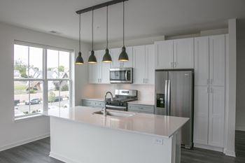 a kitchen with white cabinets and a white counter top at Enclave Crystal Lake Townhomes and Apartments, Illinois, 60014