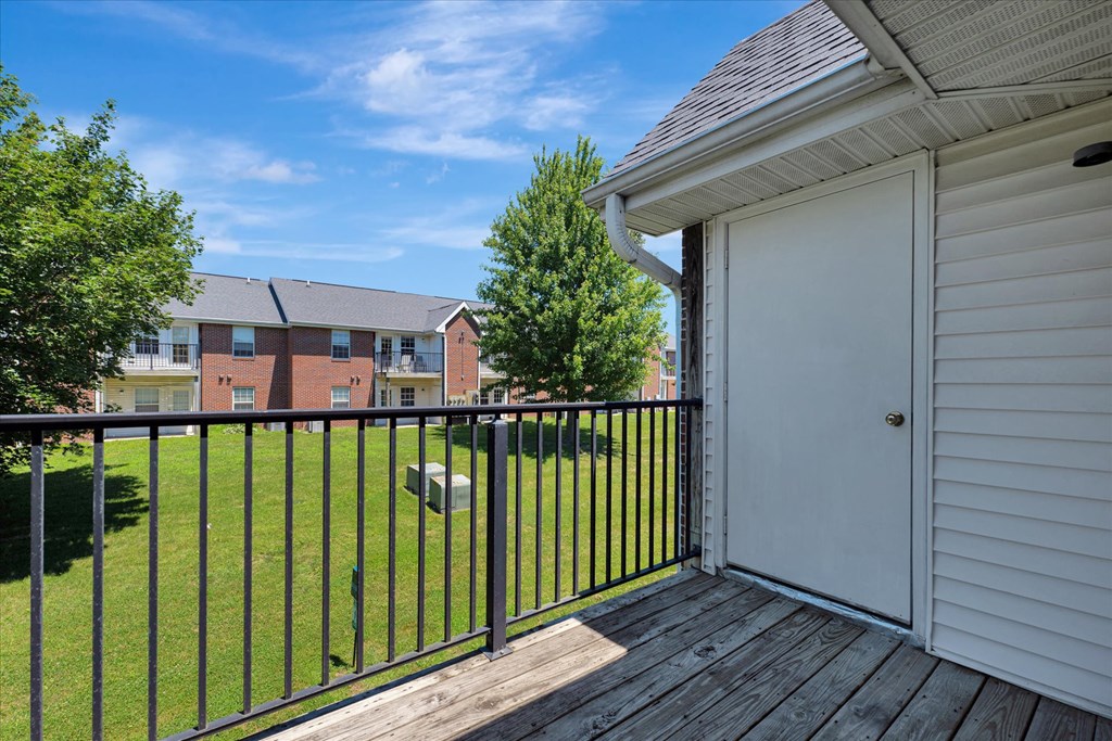 the view of a backyard from a balcony with a garage door