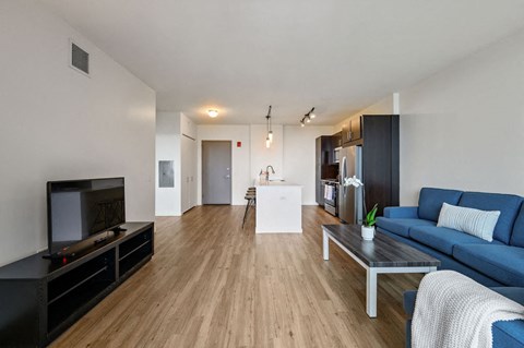 a living room with a blue couch and a coffee table at Halsted Flats, Illinois, 60613