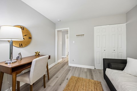 A bedroom with a bed, desk, and chair.