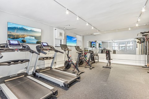 A gym with treadmills and exercise bikes.