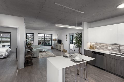 A modern kitchen with a dining table and chairs.
