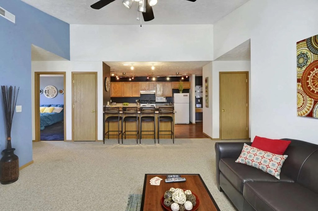 a living room and kitchen with a couch and a table