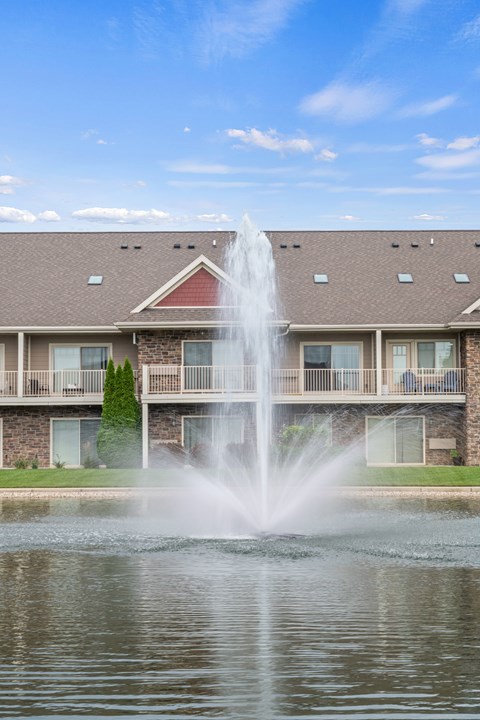 A building with a water fountain in front of it.
