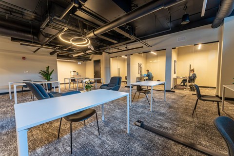 A conference room with a long white table and chairs.