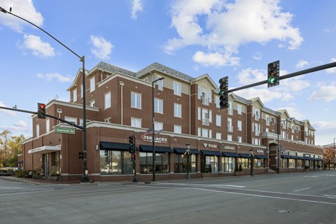 A street view of a building with the name "Per Faces" on it.
