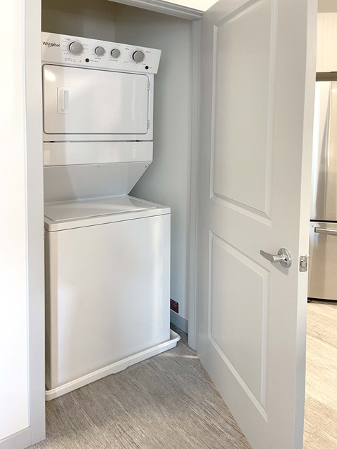 A white oven and dishwasher are built into a kitchen cabinet.