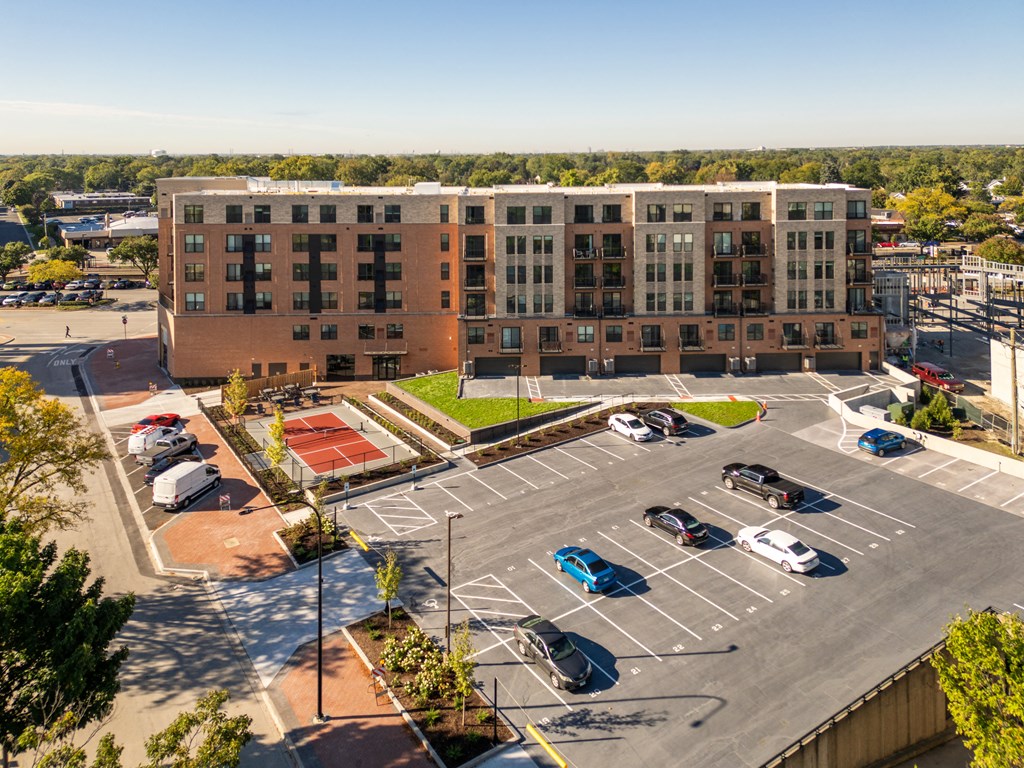 an aerial view of a parking lot and a building