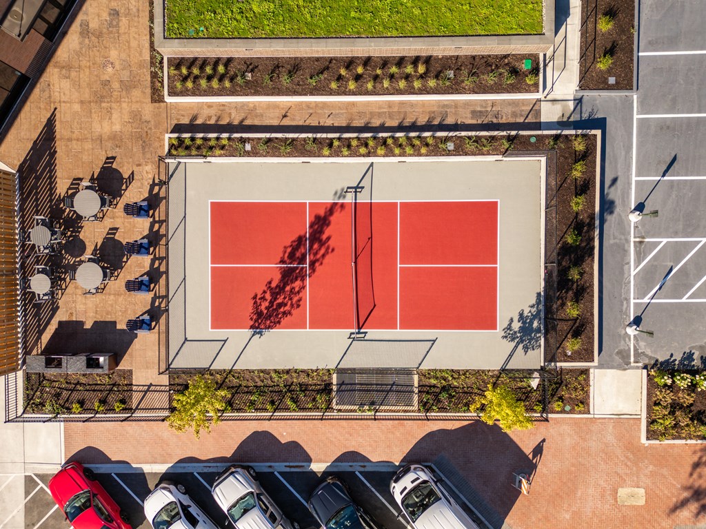an aerial view of a tennis court in a parking lot